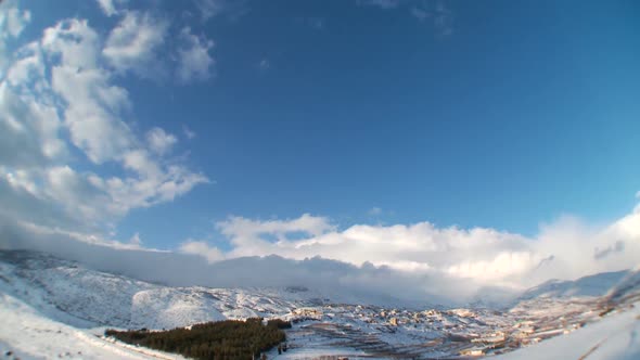 Clouds time lapse over snowy landscape