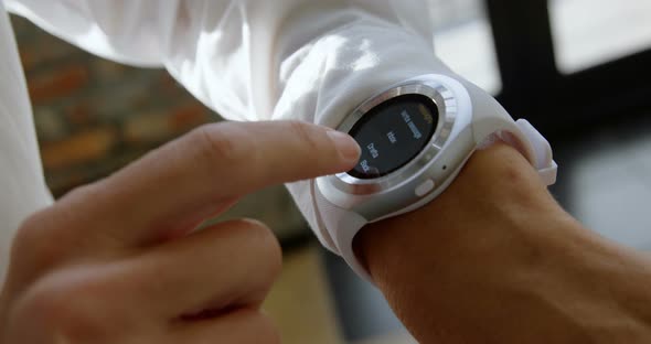 Female executive using smartwatch in office 