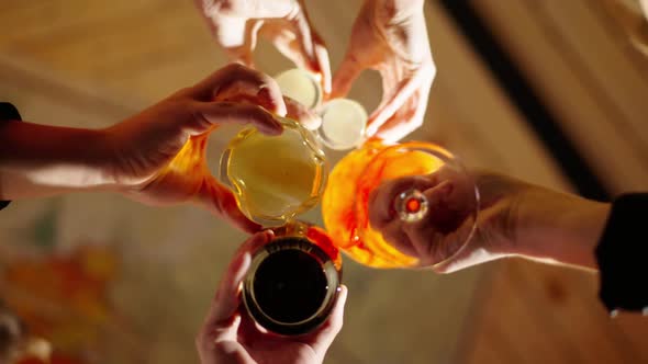 Group of Happy Multiethnic Friends Having Fun Together Drinking Bottled Beer in a Bar or at Home