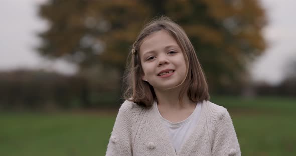 Portrait shot of a cute little girl smiling and looking at camera