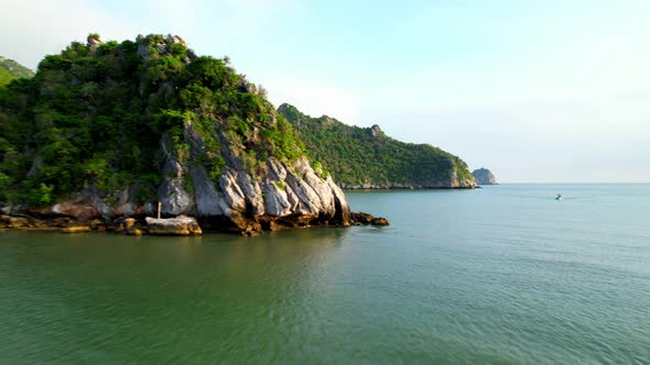 A fisherman is sailing in the sea among the islands near the coast.