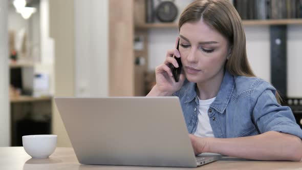 Young Girl Talking on Phone at Work