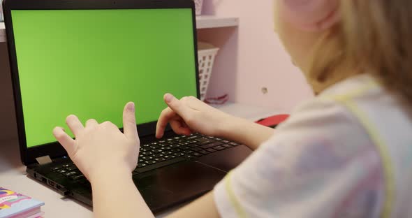 Teenage Girl Studding at Home on Laptop Computer with Green Screen at Home