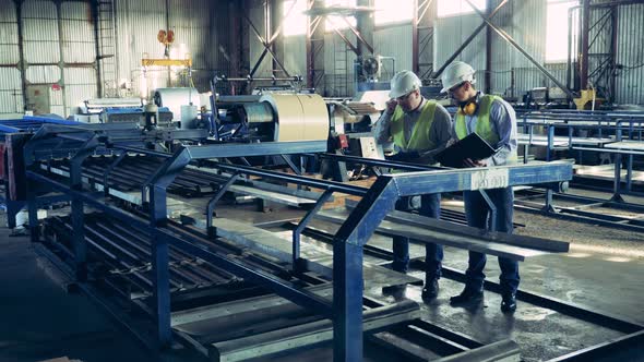 Workers Are Observing a Factory Conveyor with Metal Shingles