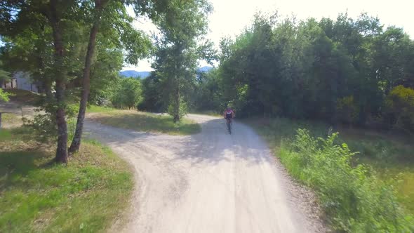 Man cycling with mountain bike on countryside road