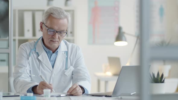 Portrait of Cheerful Senior Doctor at Work