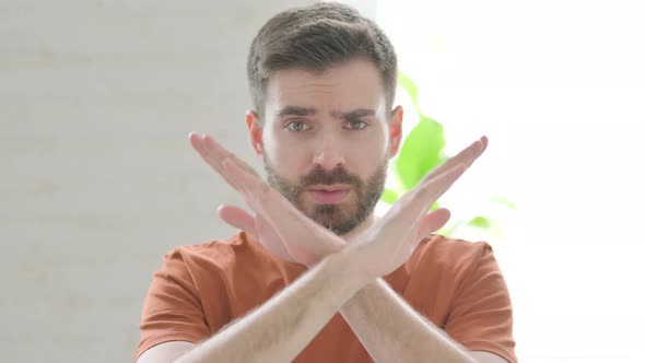 Denying Young Man Rejecting with Crossed Arm Gesture