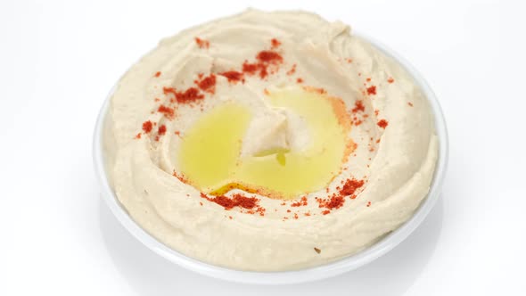 plate of hummus with smoked paprika and olive oil on white background. Healthy vegan food