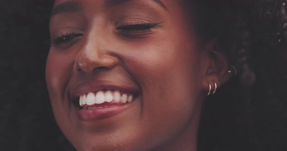 Attractive african woman smiling during a windy and sunny day