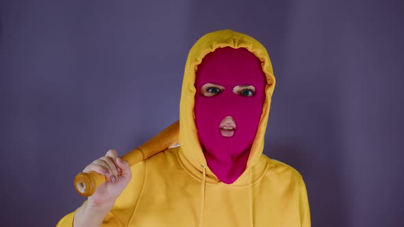 Young Woman in Pink Balaclava with Baseball Bat