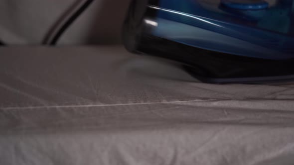 Woman Ironing Clothes on Ironing Board Closeup