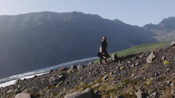 Travelling Man Hiking Up Rocky Hillside