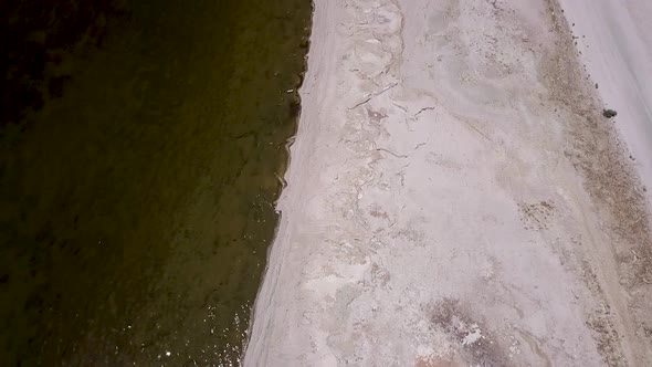 Drone Flying over desert next to sea, ocean, lake - salton sea, california