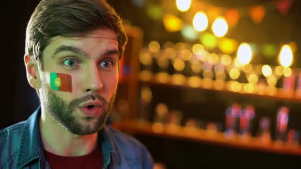 Portuguese Football Fan With Flag on Cheek Cheering for National Team, Victory