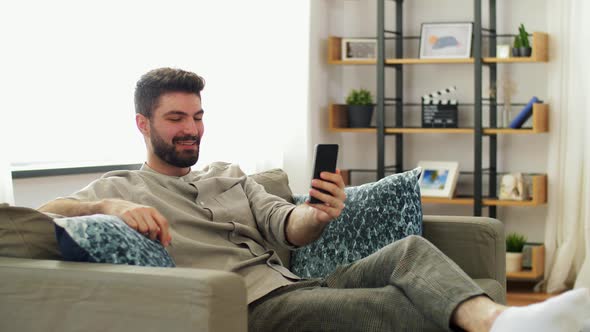 Man with Smartphone Having Video Call at Home