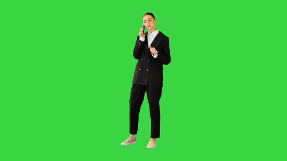 Young Female Office Worker Talking on Mobile Phone Smiling on a Green Screen Chroma Key
