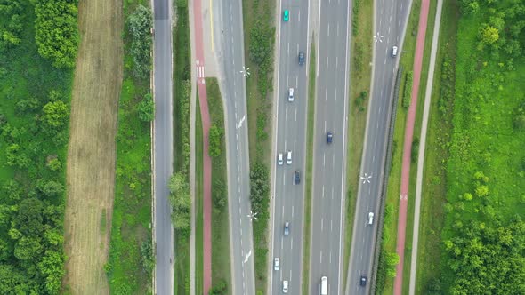 Aerial view over a highway interchange during peak hour traffic.