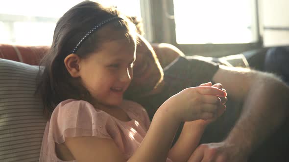 Father and daughter looking at smartphone together