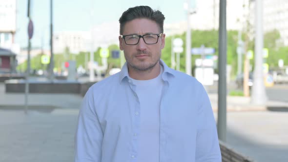 Portrait of Man Looking at the Camera Outdoor