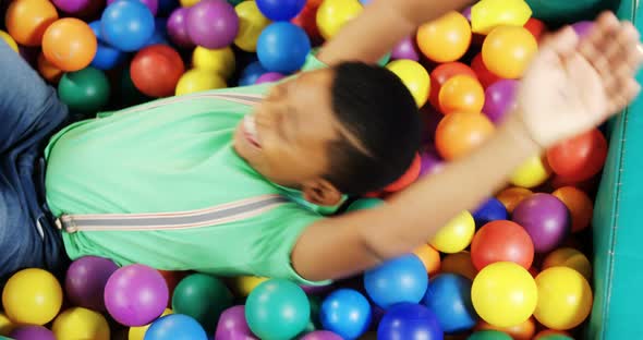 Boy playing in ball pool 4k alt