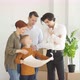 Family And Real Estate Agent Communicating While Examining Blueprints - VideoHive Item for Sale