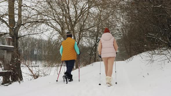 Women with Trekking Poles in the Park in Winter