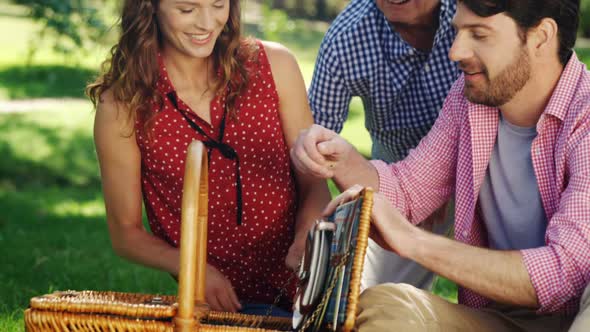 Family looking at wicker basket in the park