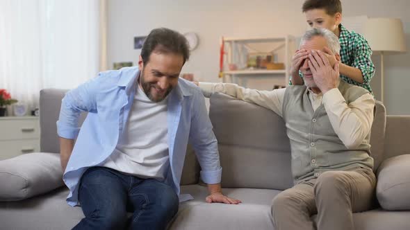 Father and Son Making Birthday Surprise for Senior Grandpa, Giving Gift Box