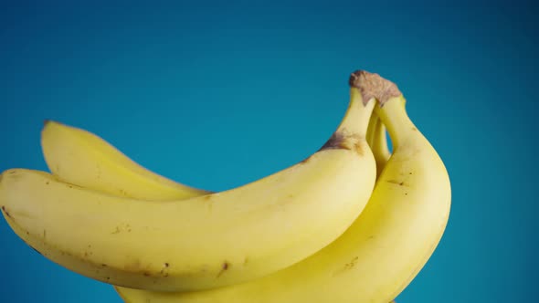 Bunch of Yellow Bananas Spinning on a Blue Background