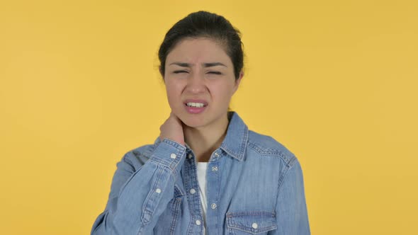 Indian Woman Having Neck Pain, Yellow Background 