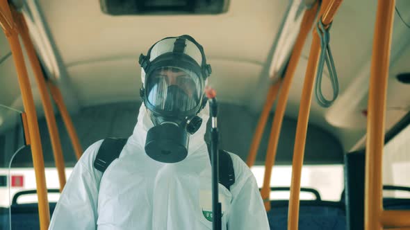 Sanitary Inspector in a Hazmat Suit During Bus Disinfection