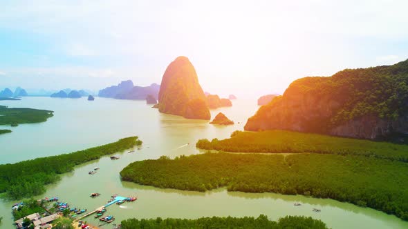 Aerial view from a drone over many islands at Phang Nga Bay during sunset time