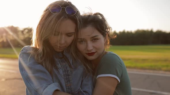 CINEMATIC SHOT Portrait of Two Young Women Stay on Road in Sunset