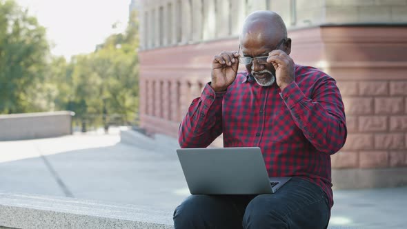 Black Elder Man Taking Off Glasses Massaging Nose Bridge Feels Unhealthy Reduce Eye Strain After