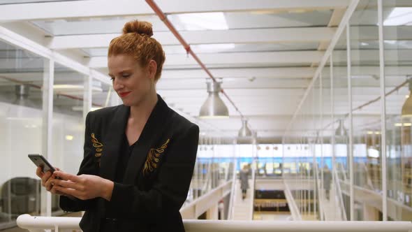 Businesswoman using mobile phone in office 4k