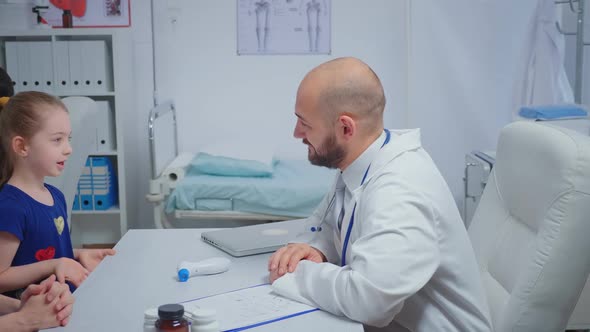 Friendly Doctor Doing High Five with Child