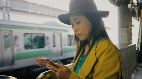 Japanese woman waiting for a train in Tokyo Japan