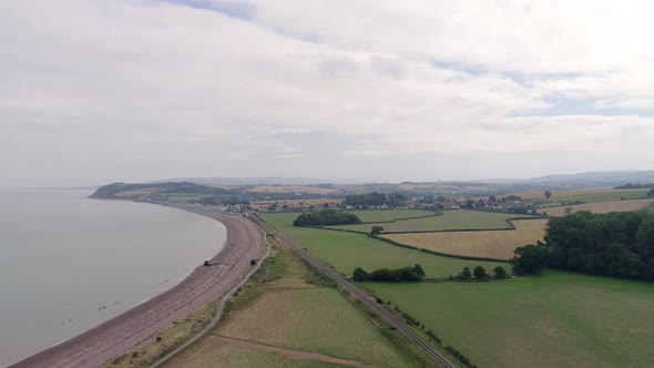 Wide shot aerial over the countryside at the coast of Blue Anchor in Somerset, near the town of Mine