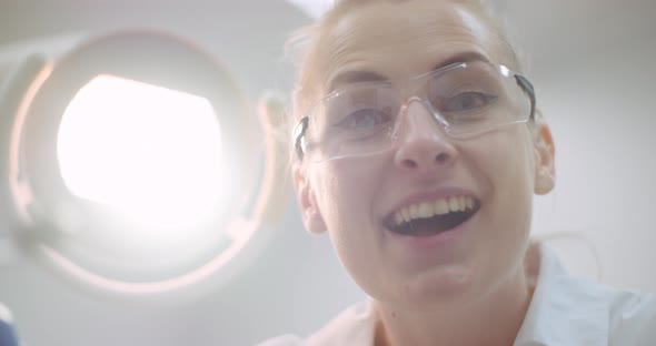 Young Positive Female Dentist Smiling at Dental Clinic