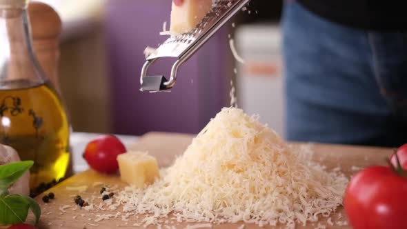 Making Pasta Carbonara  Grating Parmesan Cheese on Wooden Cutting Board