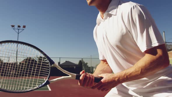 Man playing tennis on a sunny day