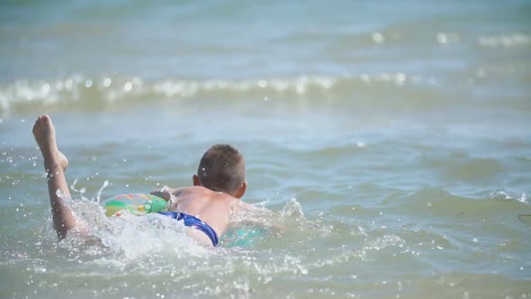 a Boy with a Circle Swims