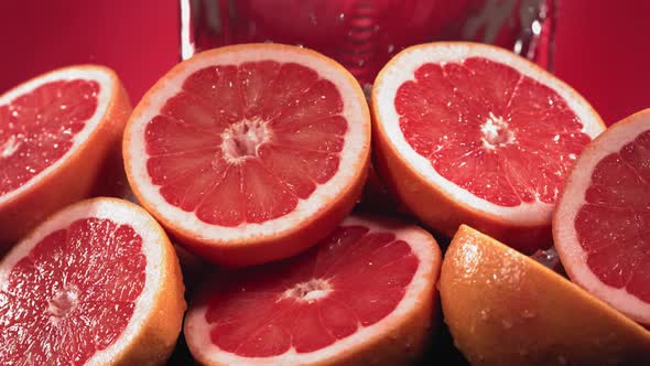 Slow Motion Shot of Grapefruit Water Splashing Through Grapefruit Slices