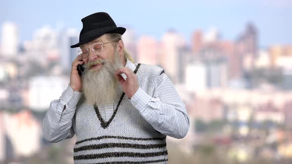 Bearded Man in Hat Talking on Cell Phone