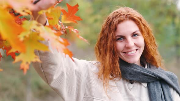 Young Beautiful Woman In Autumn Forest Explore and Enjoy Nature