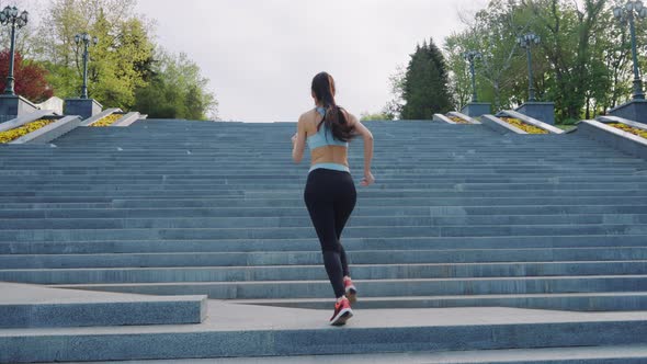 Fit Woman Running Upstairs in Park