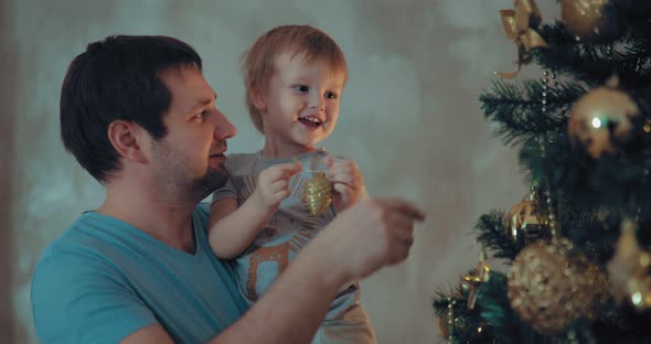 Dad and Son Decorate the Christmas Tree