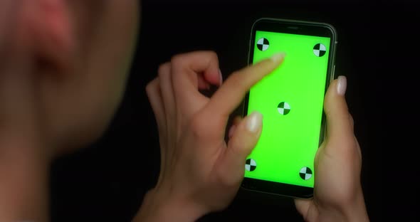 Woman Using Mobile App on Green Screen Phone Swipes Up