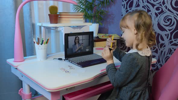 Preschool Child Girl Distance Online Education at Home Pupil Watching Video Lessons on Laptop