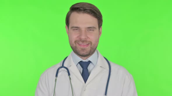 Smiling Young Doctor on Green Background